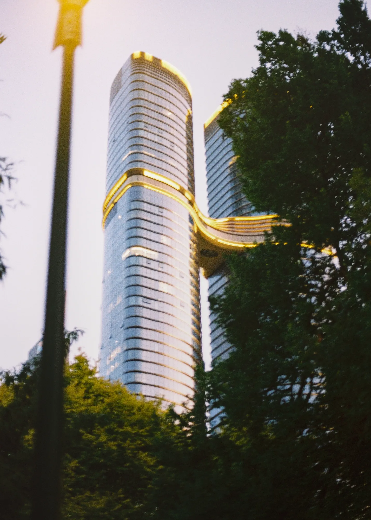 Tall building reaching upward, color film